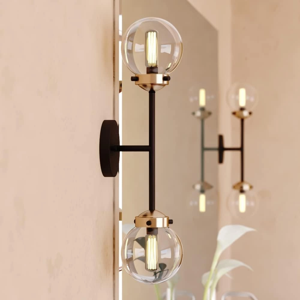 VAXCEL Orbit 2 Light Brass and Oil Rubbed Bronze Industrial MCM Wall Sconce Clear Glass Globe